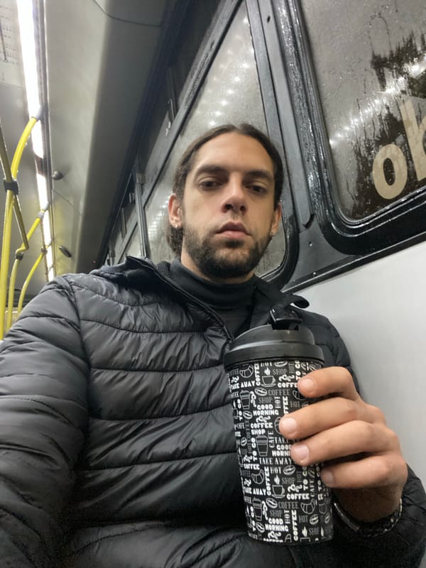 Morning commuter drinks coffee on Buenos Aires public transport