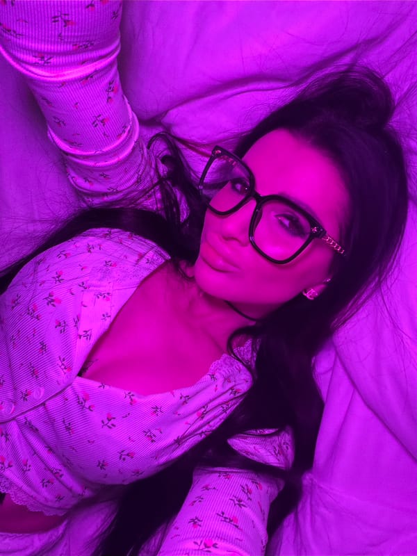 Woman takes selfies in purple-lit bedroom in Voronezh