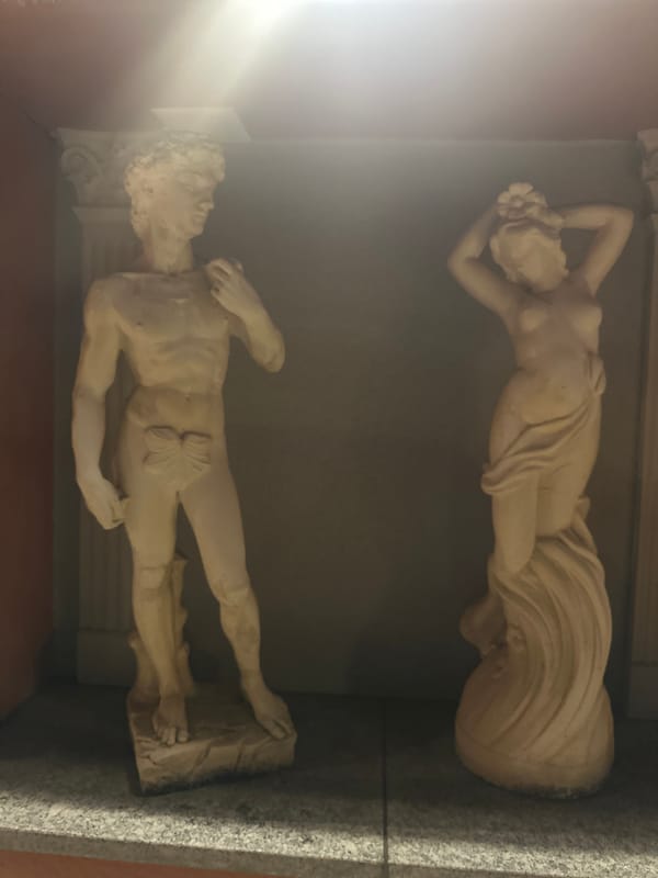 Plaster sculptures of reclining figures displayed indoors in Zurich