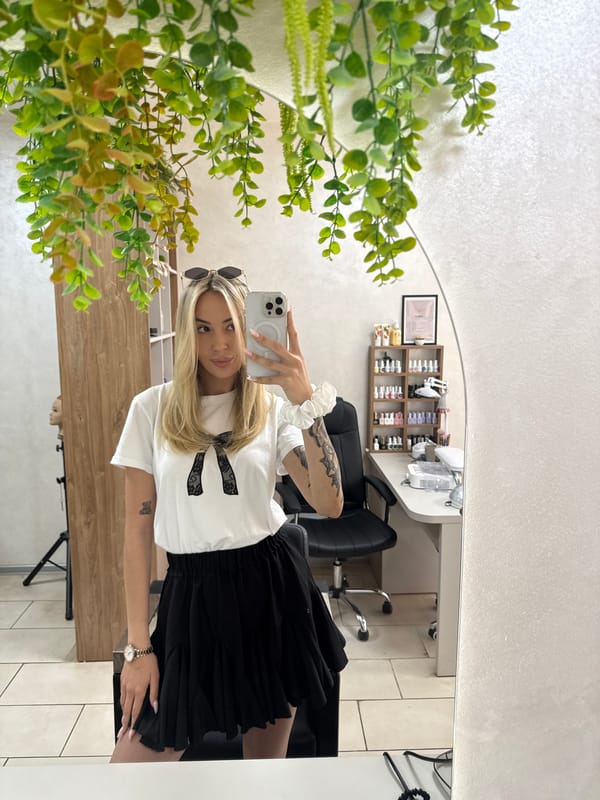 Woman takes mirror selfies at salon in Ruse, Bulgaria