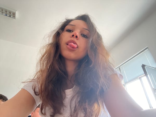 Woman takes playful selfies from multiple angles indoors