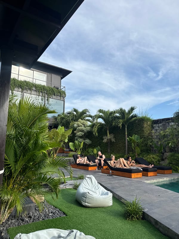 Resort guests enjoy morning poolside relaxation under sunny skies
