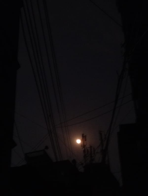Telecommunications tower photographed at night in Dhaka