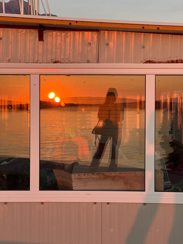 Woman sits on waterfront rocks in Bar, Montenegro