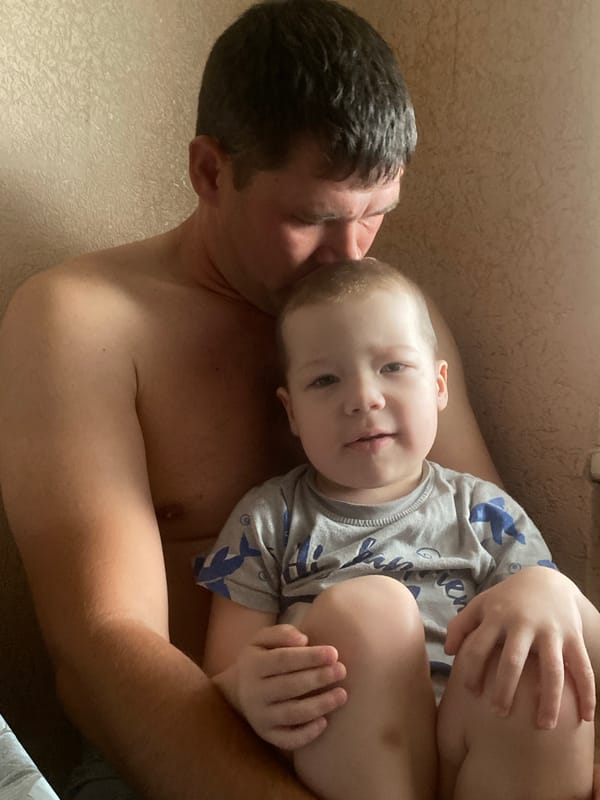 Father and child share quiet moment in Sochi