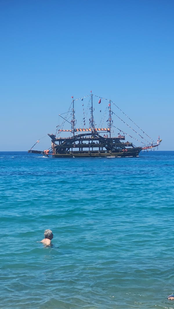 Alanya beach in full summer swing, pirate boat included.