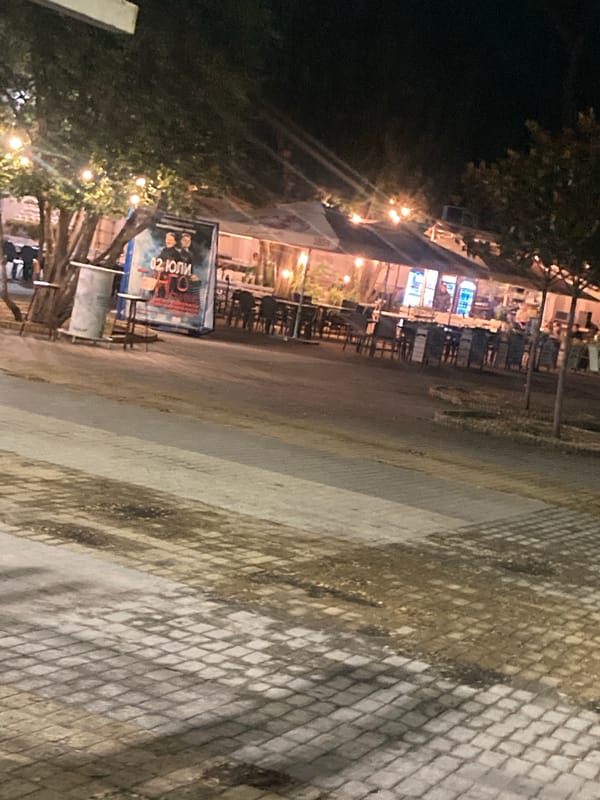 Cozy outdoor cafe glows with string lights after dark