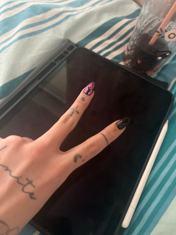 Person makes peace sign while using iPad in Sofia