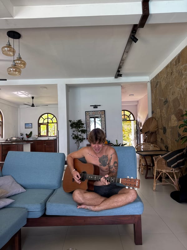 Acoustic guitar session on a blue sofa, Goviyapana
