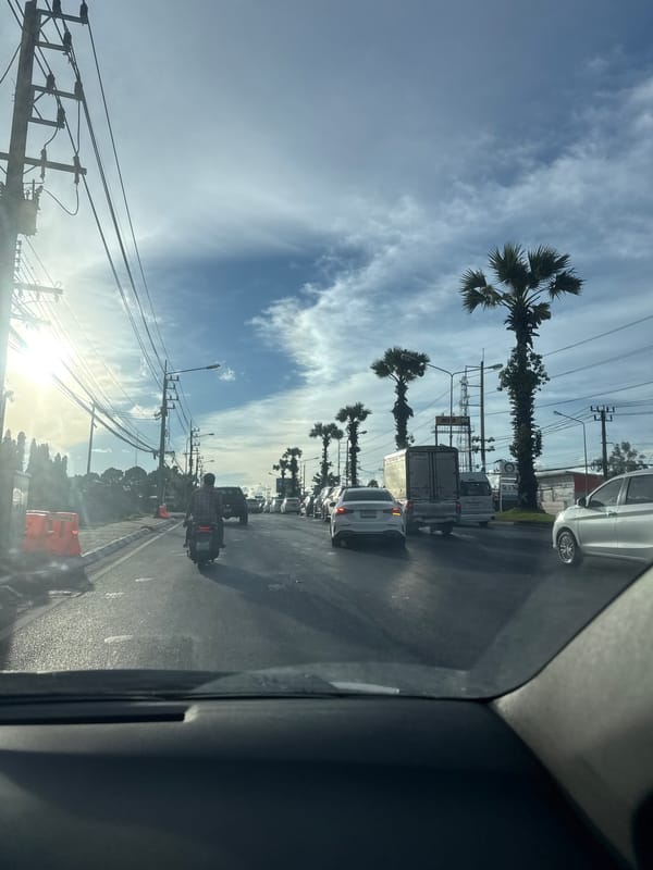 Sunny drive through palm-lined streets of Ko Kaeo, Thailand