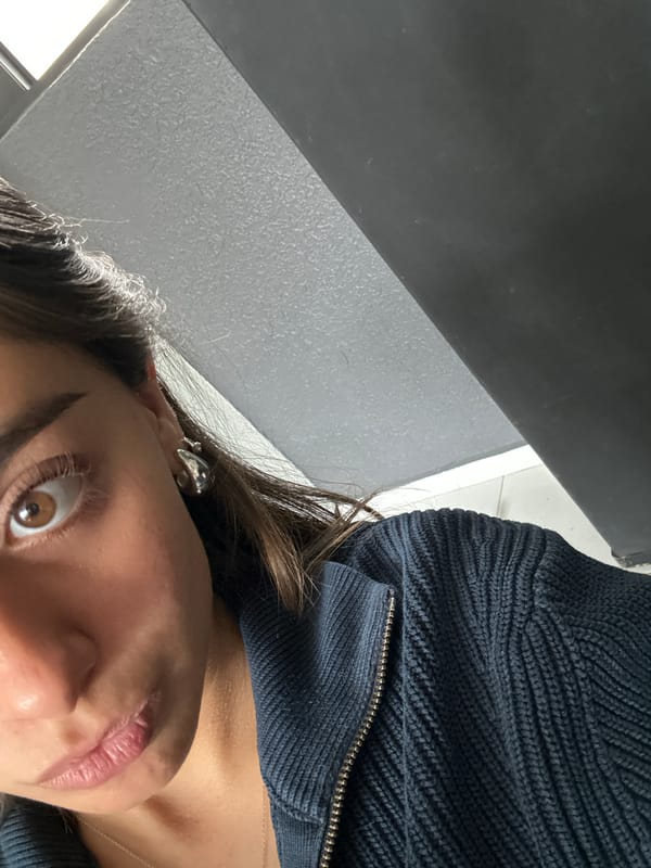 Person takes multiple selfies indoors wearing blue sweater