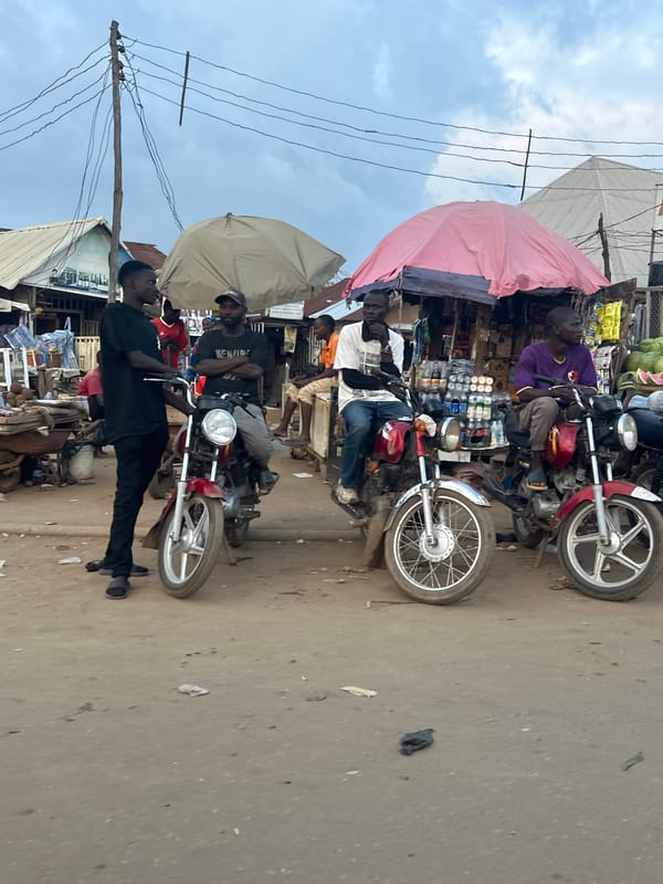 Street market activity and Keke Napep in Abuja afternoon