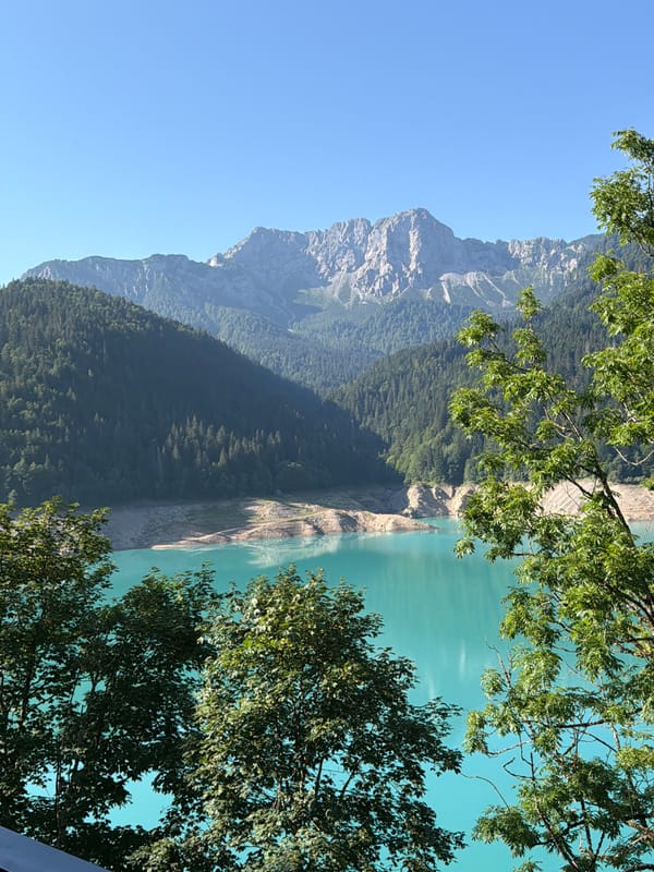 Turquoise alpine lake in Lateis on a clear summer morning