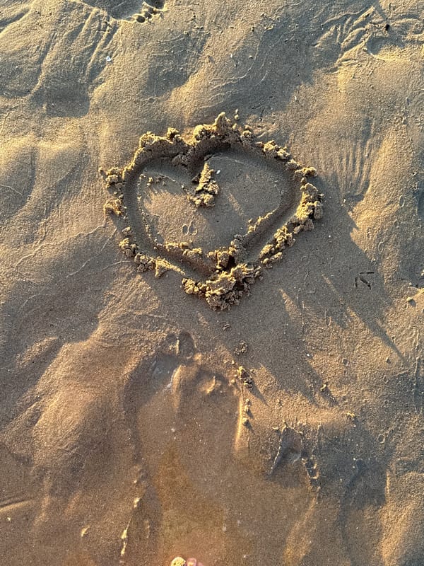 Golden hour at Cascais beach, sand art and seagulls at sunset