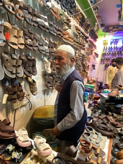 Evening shoe shopping and market activity in Kandahar