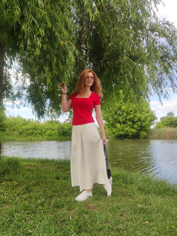 Woman poses for photos by water in Irpin, Ukraine