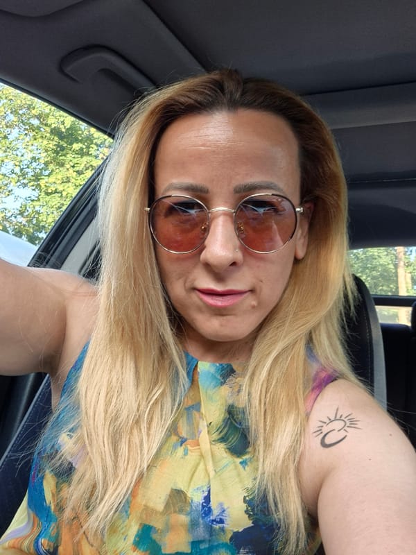In-car selfie session with colorful outfit and pink sunglasses