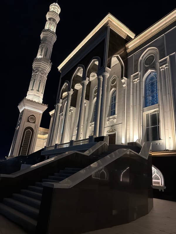 Nur-Astana Mosque glowing at night amid Astana's cityscape