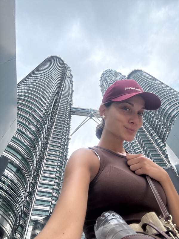 Woman photographed at Petronas Twin Towers in early morning