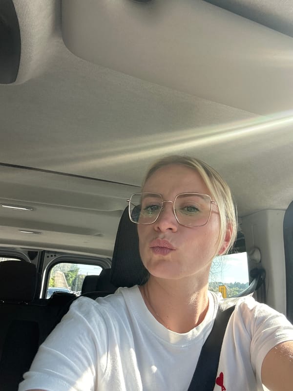 Woman playfully sticks tongue out while traveling in Antibes