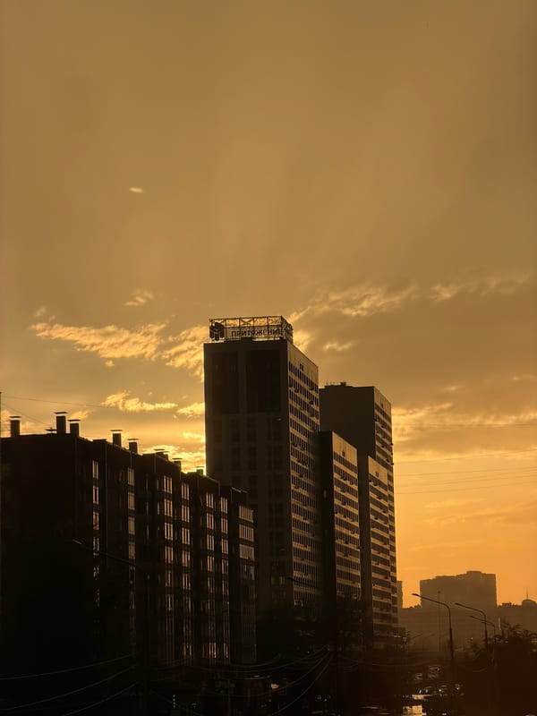 Double rainbow and sunset over Krasnoyarsk's urban skyline