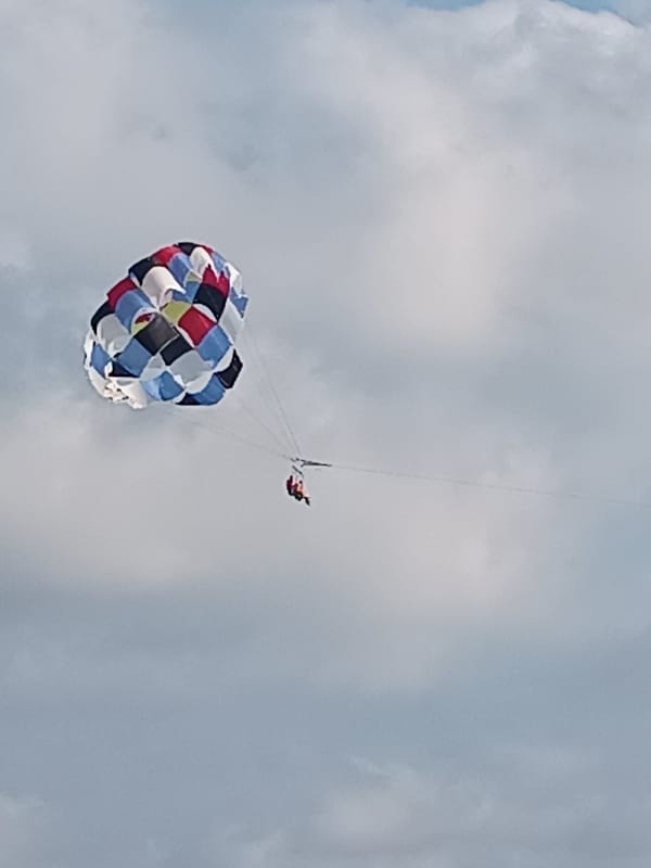 Parasailing over Manavgat under a colorful canopy