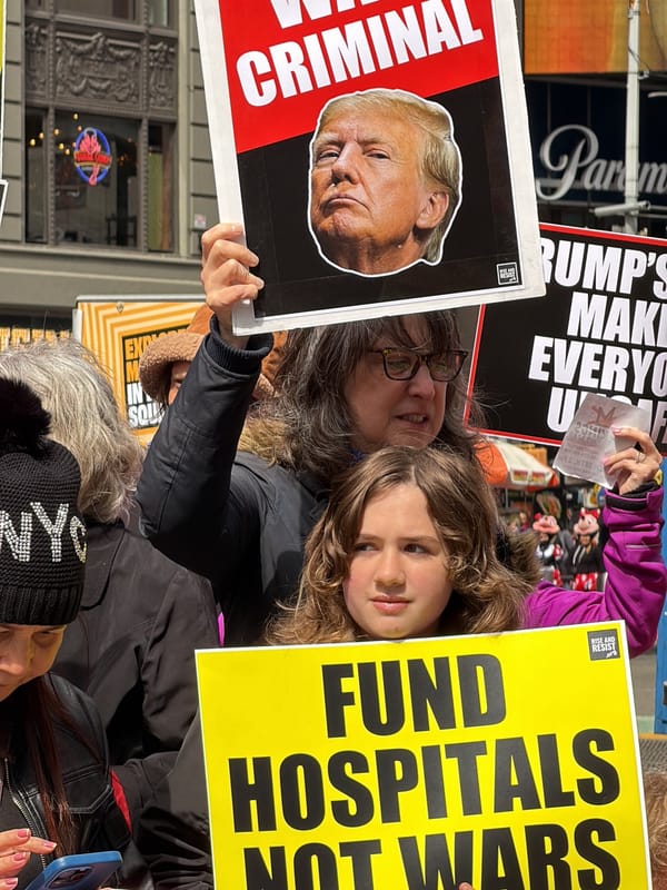 Anti-war protesters demonstrate in Times Square with megaphones, signs