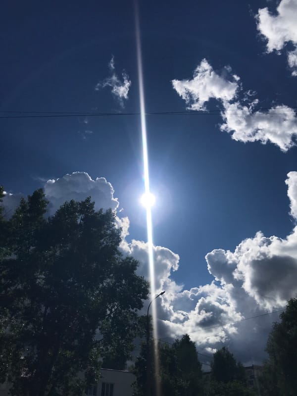 Child plays with toy under sunny skies in Chaikovsky