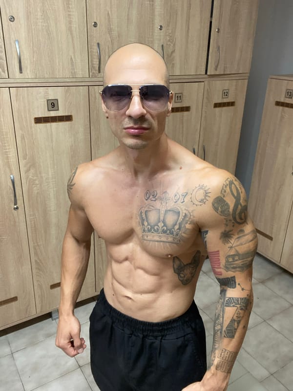 Tattooed figure moves through Pleven — locker room to car