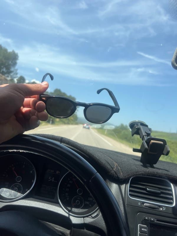 Passenger displays Dior sunglasses while traveling highway near Derdara, Morocco
