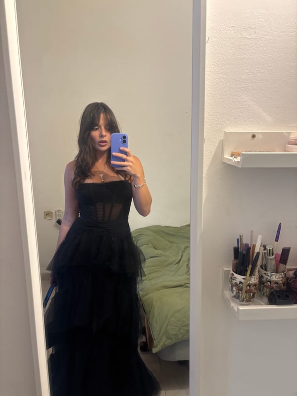 Woman takes mirror selfie in black dress, Tel Aviv