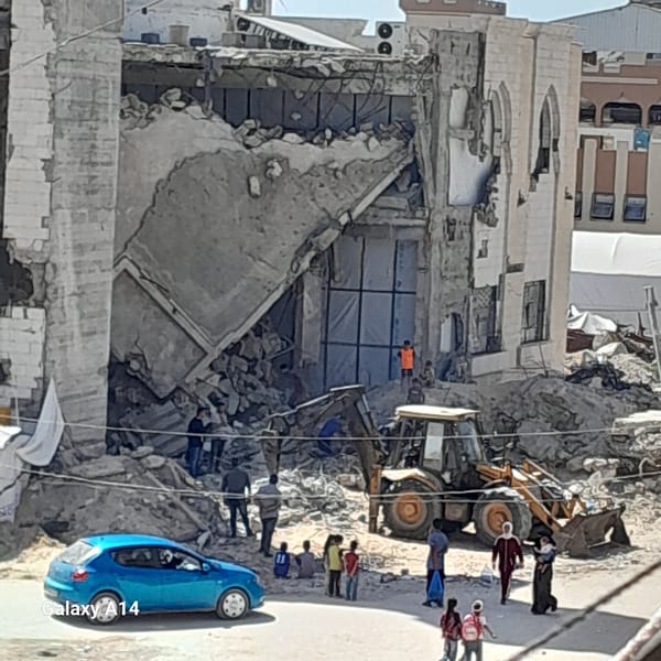 Cleanup crews work at collapsed building in Khan Yunis