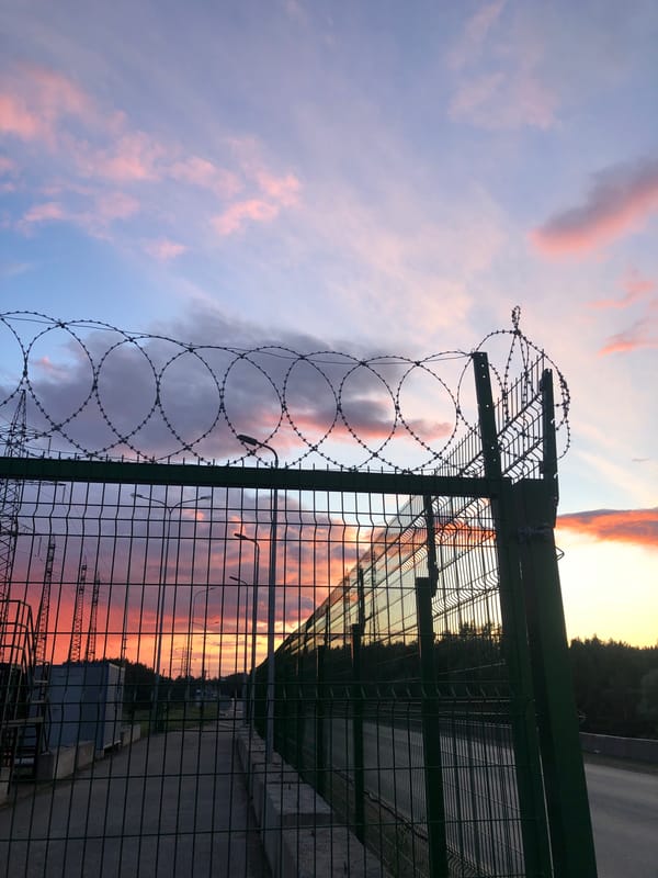Sunset scenes documented along fenced roadway in Noviy, Russia
