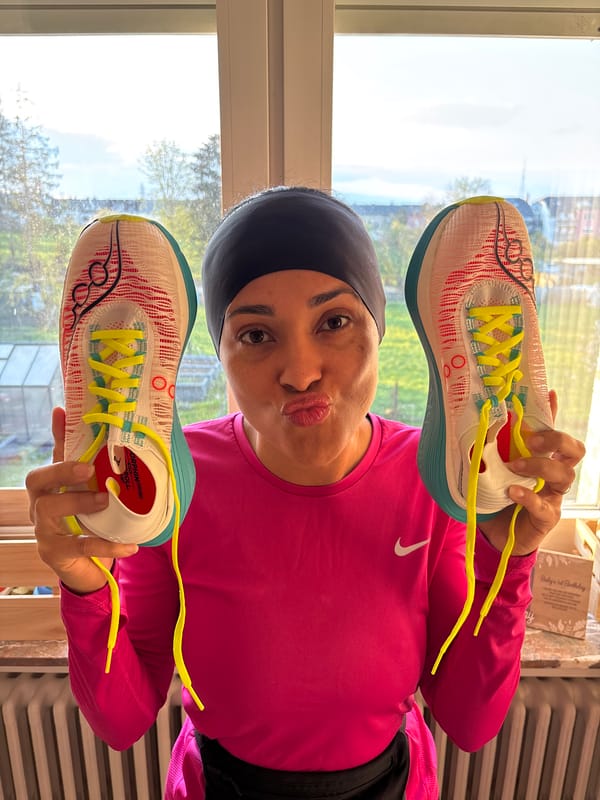 Woman playfully poses with running shoes in Luxembourg home
