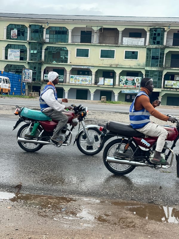 Roadside life along a busy Lokoja junction on a wet morning