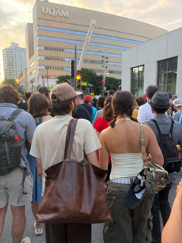 Crowd gathers on the street outside UQAM in Montreal