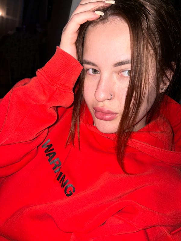 Person in Warning Hoodie Spotted in Contemplative Pose, Russia