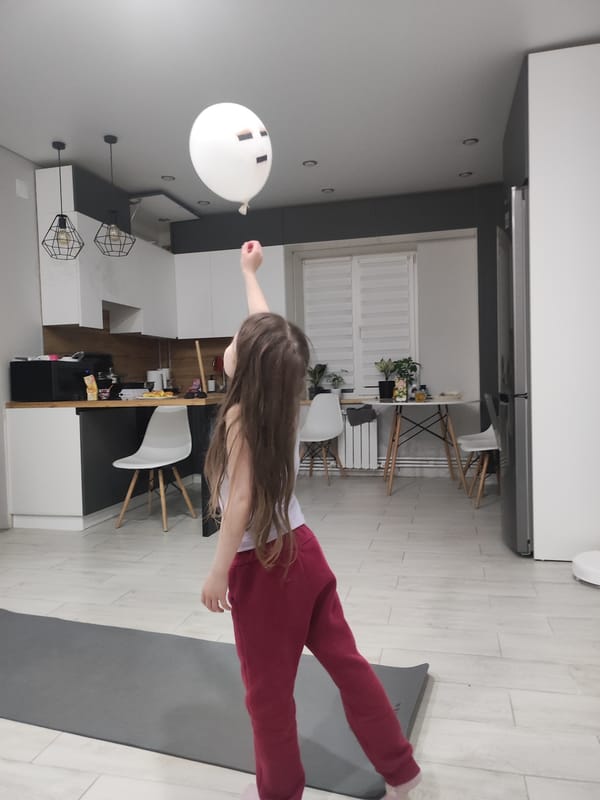 Child plays with balloon on yoga mat in Votkinsk home