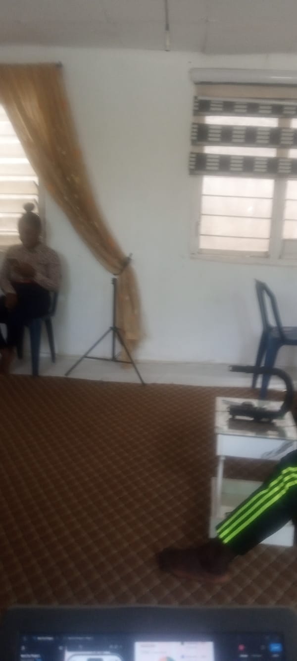 Person sits by window in carpeted room, Rido Nigeria