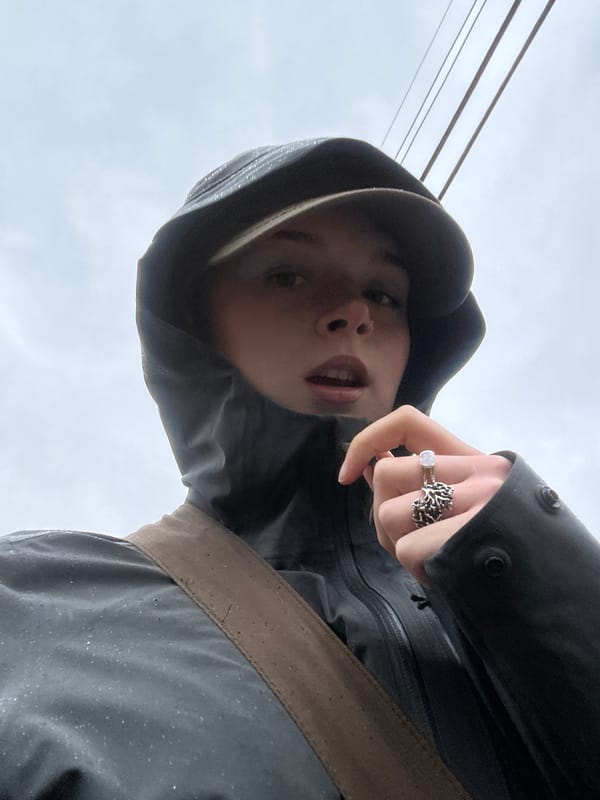 Person in rain gear photographed on Vancouver sidewalk