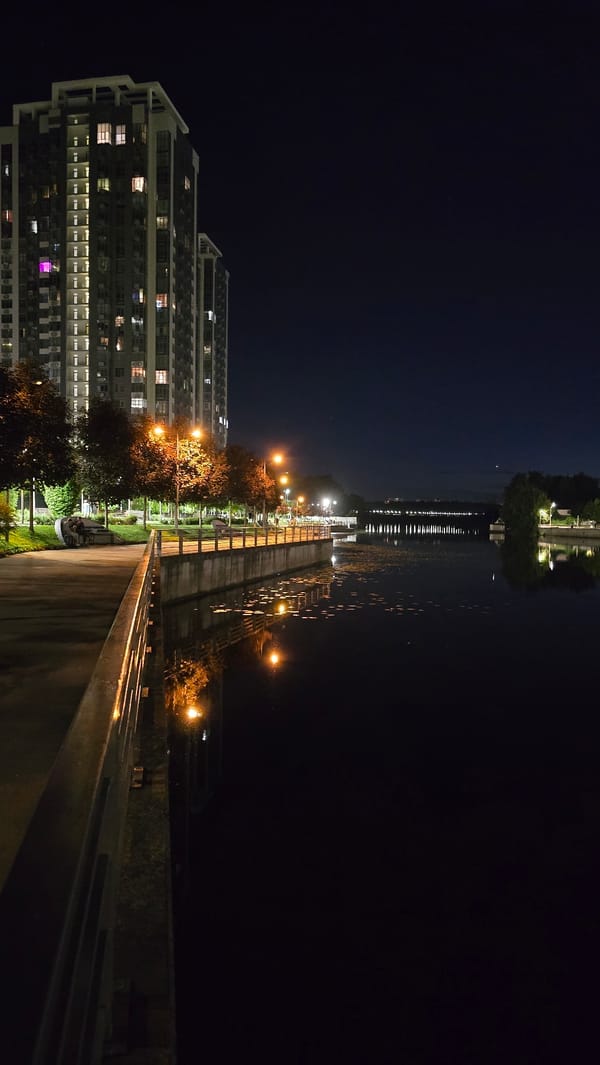 Kyiv's illuminated Dnipro embankment captured from multiple nighttime angles