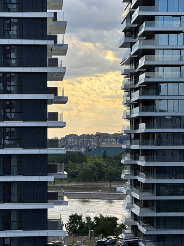 Modern Belgrade skyline under dramatic evening clouds