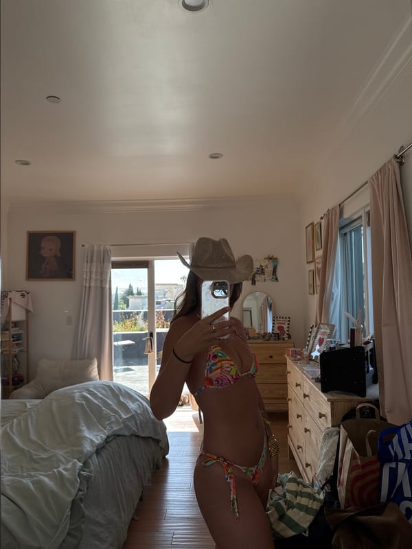 Woman Takes Mirror Selfie in Bikini and Cowboy Hat