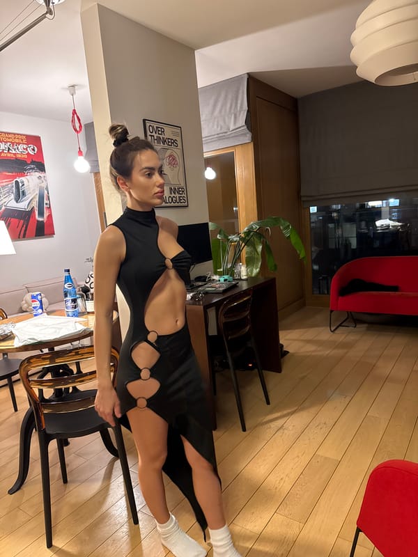Woman poses in black dress at Warsaw apartment