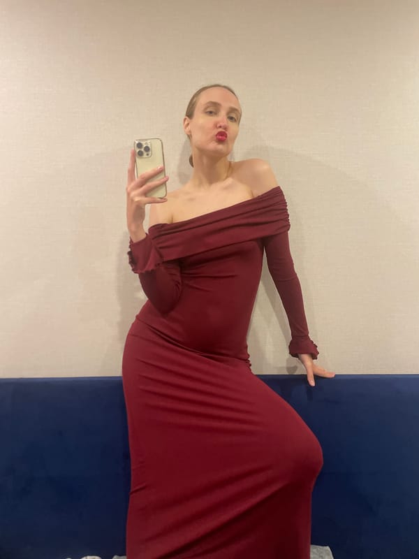 Woman takes selfies in red dress in Russian town