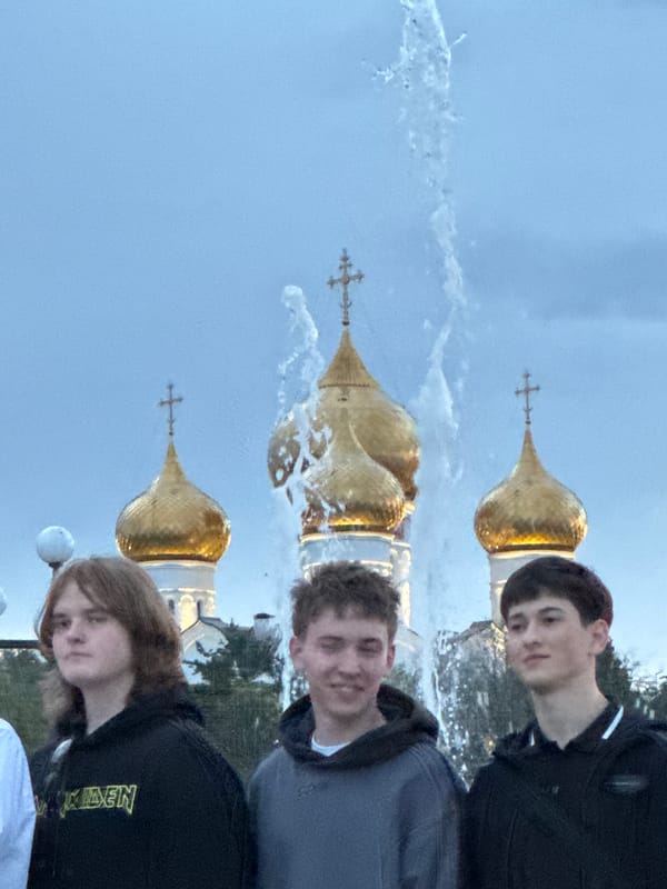 Graduation group photos near a fountain with golden domes