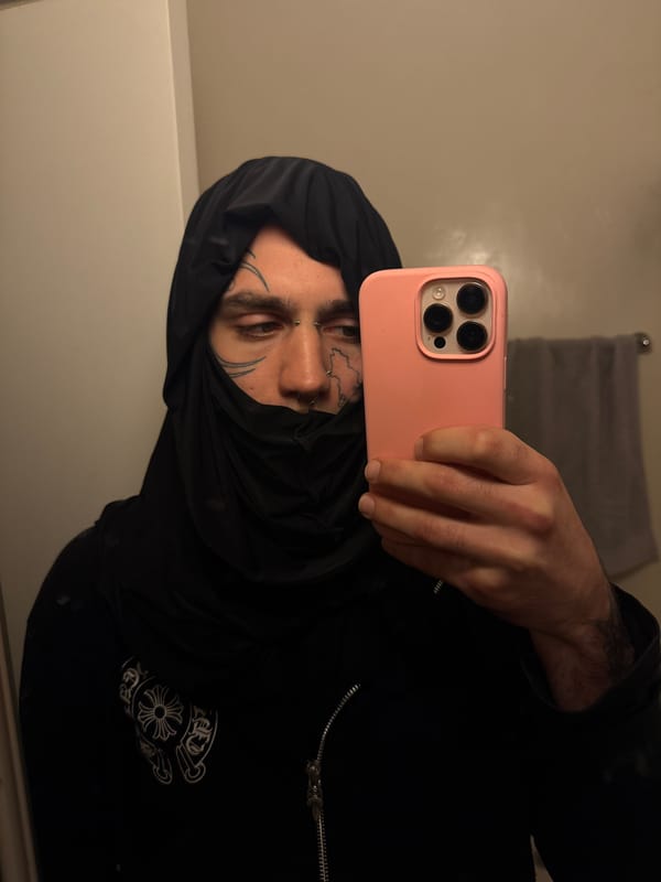 Tattooed individual takes indoor selfie in Buenos Aires