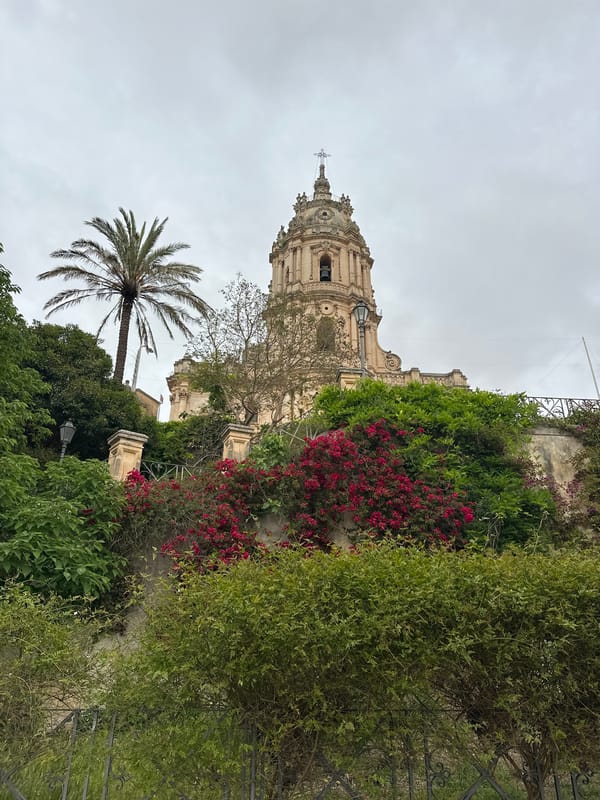 Tourist documents baroque cathedral and hillside views in Modica, Italy