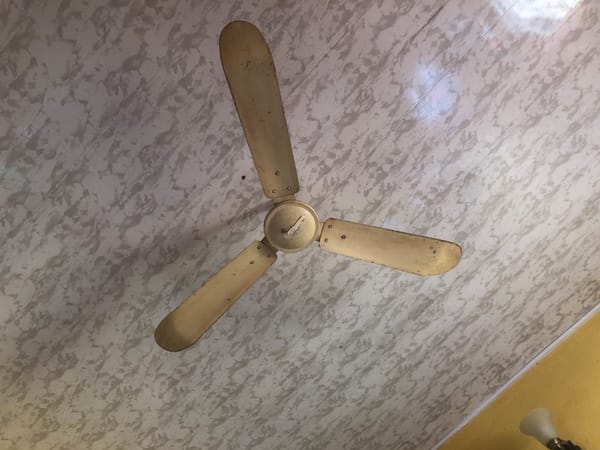 Worn ceiling fan observed in residential setting