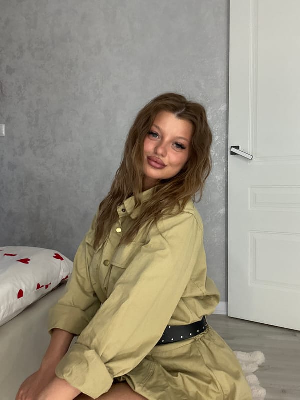 Woman photographs outfit changes in indoor Omsk session